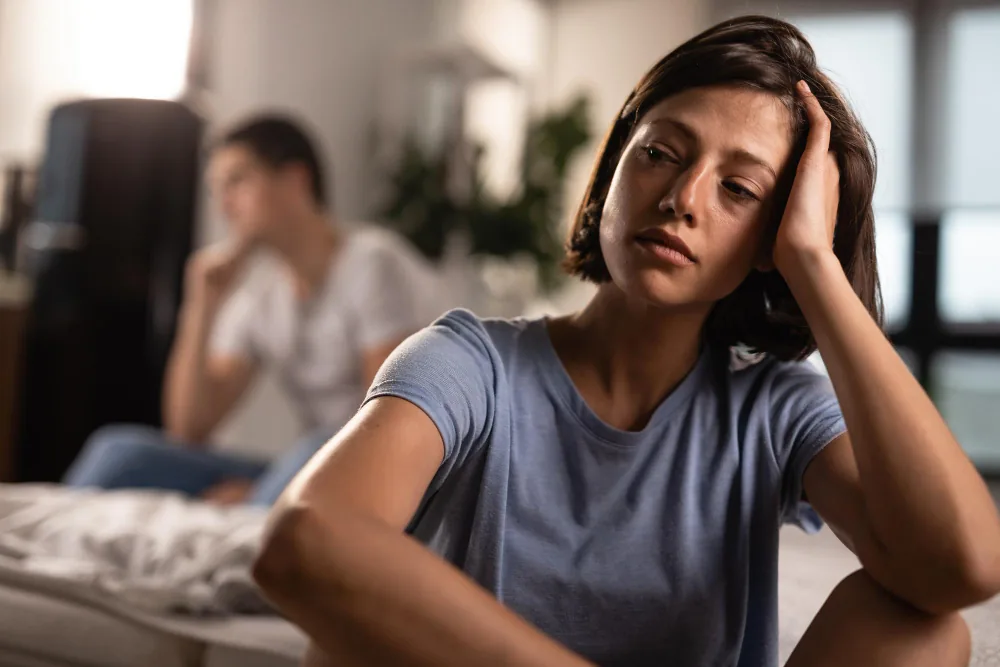 Woman struggling to concentrate while reviewing notes in a distracting environment