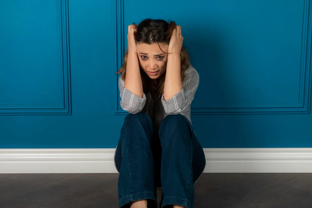Woman experiencing mood-related distress while seeking support for bipolar disorder symptoms