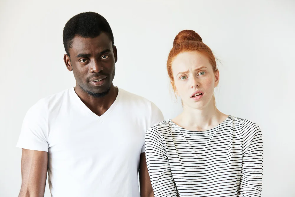 Couple sitting apart while experiencing emotional distance connected to depression