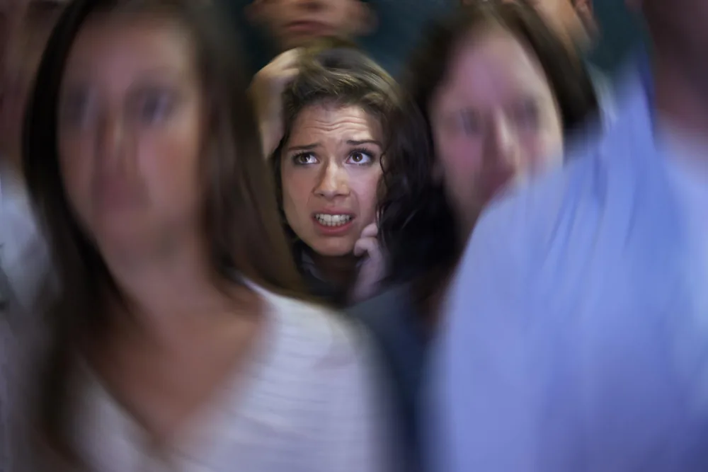Woman appearing distressed by persistent unwanted intrusive thoughts during a quiet moment