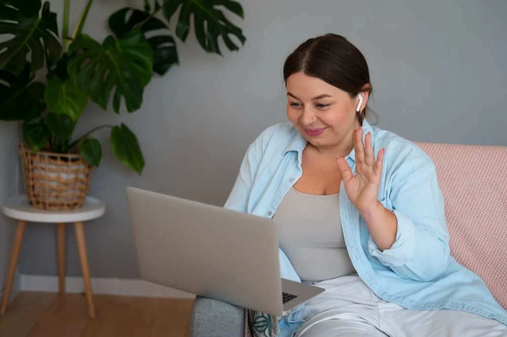 Young adult speaking with a psychiatric provider during a virtual appointment
