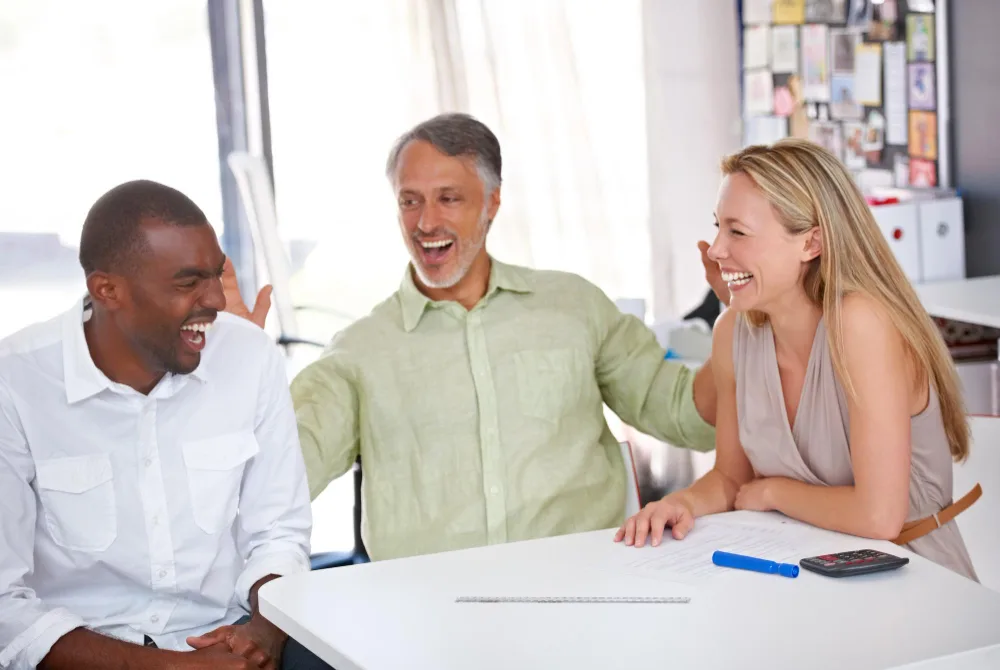 Psychiatric clinician speaking with a patient and supportive partner while reviewing treatment concerns