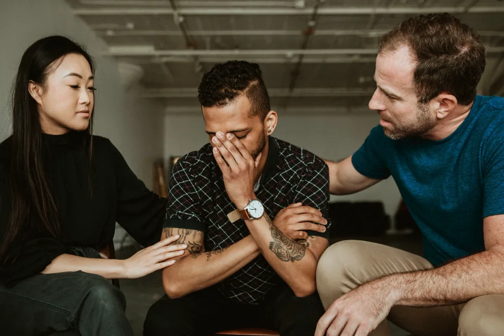 Family supporting a loved one while managing emotional distress