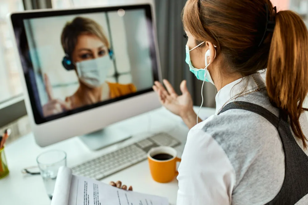 Patient attending a secure online psychiatry appointment using a laptop